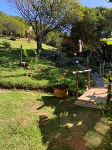 un jardín con porche y una maceta de flores en Recanto da Vila - Suíte 01, en Governador Celso Ramos