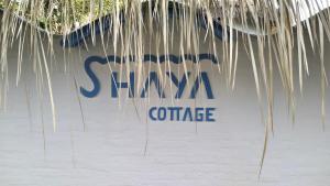 a sign for a sigma conference on a wall at SHAYA cottage in Sekotong