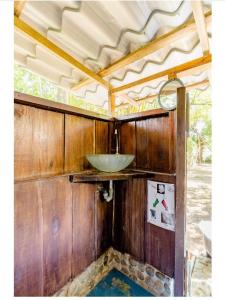 a bathroom with a sink in the back of a train at Luminosa Uvita Hostel in Uvita