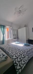 a bedroom with a bed with a black and white comforter at 7ROOMS Grancia in Lugano