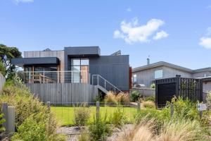 a modern house with a fence and a yard at Stage 1 in Point Lonsdale