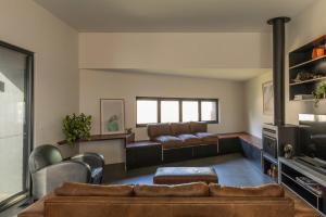 a living room with a couch and a tv at Stage 1 in Point Lonsdale