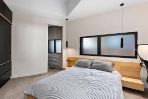 a bedroom with a bed and a mirror on the wall at Stage 1 in Point Lonsdale