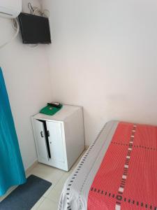 um quarto com uma cama e uma televisão na parede em HOSTAL KENNDY em Valledupar