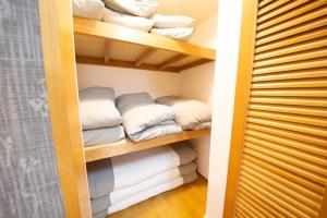 a closet filled with lots of towels and pillows at la3 hotel 新宿三階建て一軒家（屋内エレベーター付き) in Tokyo +58 photos