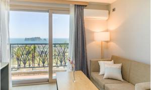 a living room with a couch and a view of the ocean at Seogwipo Worldcup Resort in Seogwipo
