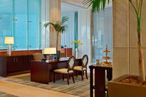 a lobby with a desk and chairs in a building at Sheraton Santiago Hotel & Convention Center in Santiago