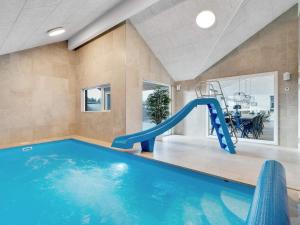 a indoor swimming pool with a slide in a house at Luxury Villa with Pool - By Traum Ferienwohnungen in Kongsmark