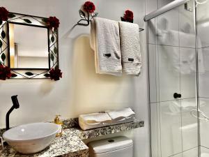 biała łazienka z umywalką i prysznicem w obiekcie Alto da Villa Loft w mieście Ouro Preto
