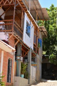 a house with a wooden roof at Casa MITA Taganga in Taganga
