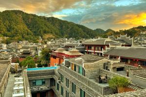 a view of a city with buildings and mountains at Phoenix Hall House Hotel in Fenghuang