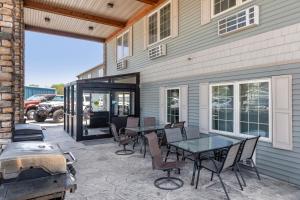 a patio with a table and chairs and a grill at The Riverstone Inn in Towanda