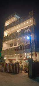 a large white building with a lot of lights on it at SAI HOME in Dehradun