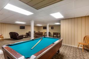a pool table in a room with chairs and a pool table at The Riverstone Inn in Towanda