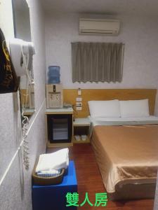 Voodi või voodid majutusasutuse Yung Feng Hotel toas