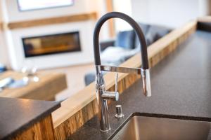 a kitchen sink with a faucet on a counter at Eagles Nest - by Alpen Apartments in Zell am See