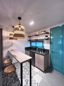 a kitchen with a table and a sink at Parallelo Loft Salento P1 in Salento