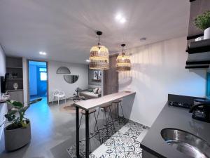 a kitchen and living room with two chandeliers at Parallelo Loft Salento P1 in Salento
