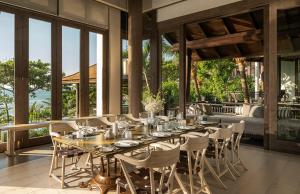 a dining room with a long table and chairs at InterContinental Danang Sun Peninsula Resort by IHG in Danang