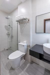 a white bathroom with a toilet and a sink at TRUONG TIEN HOTEL in Hue