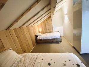 a room with two beds in a attic at Chalet Crest-Voland, 6 pièces, 10 personnes - FR-1-733-70 in Crest-Voland