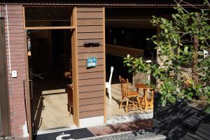 an open door to a patio with a table and chairs at The GrandWest Arashiyama in Kyoto