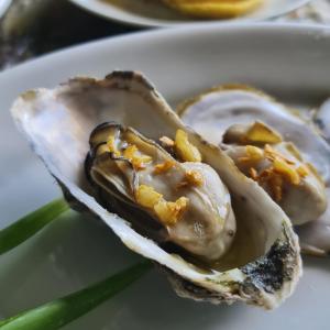 a oyster on a white plate with some food at Torrebeatrice in Bagnaia +14 photos