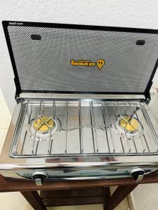 a stove top oven with two donuts on it at Departamento 2 habitaciones Trinidad Beni in Trinidad