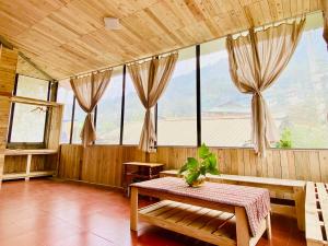 a room with a table and some windows at A Phủ Home’s in Bắc Yên