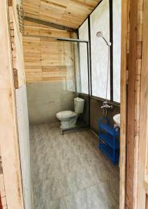 a bathroom with a toilet and a sink at A Phủ Home’s in Bắc Yên
