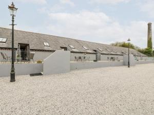 a building with a courtyard with tables and chairs at Water Wheels in St Austell