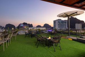 a group of chairs and tables on top of a roof at Diamond Luxury Hotel in Ha Long