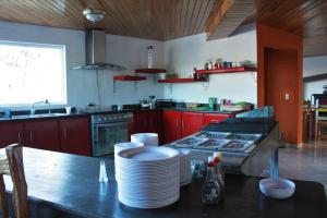 a kitchen with a stove and plates on a table at Villas la Quinta (etapa Aserradero) in Creel