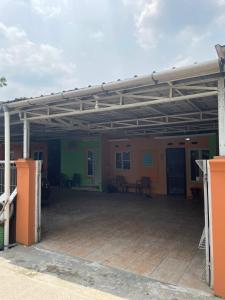 a large garage with awning and tables in it at Bu Sur Homestay in Bogor