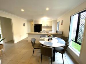 a kitchen and dining room with a table and chairs at The peaceful place to stay – in Gold Coast
