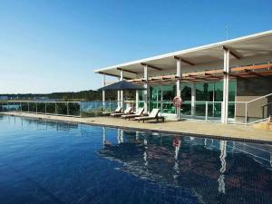 una piscina de agua con sillas y un edificio en The peaceful place to stay – en Gold Coast
