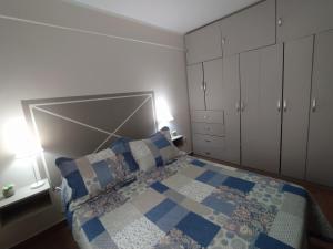 um quarto com uma cama com uma colcha azul e branca em Puñadito de descanso em Salta