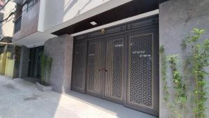 an entrance to a building with a wooden door at Era Apartment Khuc Thua Du in Hanoi