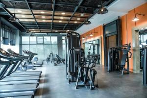 a gym with treadmills and elliptical machines at Sotogrande Hotel Katipunan in Manila