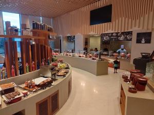 a restaurant with a buffet line with food on display at Courtyard by Marriott Madurai in Madurai