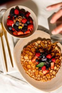 two bowls of food with berries on a table at W South Beach in Miami Beach