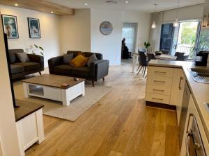 a kitchen and living room with a couch and a table at Andy & Anna's Weekend Hideaway in Newcastle
