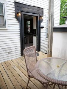 a table and a chair on a wooden deck at Historic German Village Home/A+ Downtown Location in Columbus