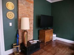 a living room with a television and a lamp at Historic German Village Home/A+ Downtown Location in Columbus