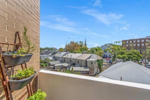 a balcony with potted plants and a view of a city at Andy & Anna's Weekend Hideaway in Newcastle +9 photos