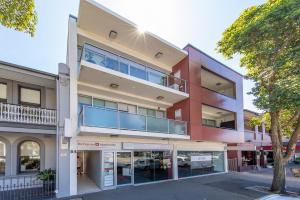 an apartment building with balconies on a street at Andy & Anna's Weekend Hideaway in Newcastle
