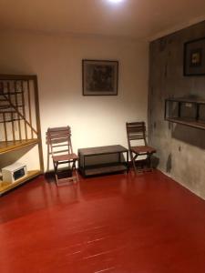 a living room with two chairs and a table at Phi Phi Dream Guest House in Phi Phi Islands