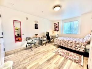 a bedroom with a bed and a table and chairs at Micro Studio Apartment in University District- 10 mins walk to University of WA in Seattle
