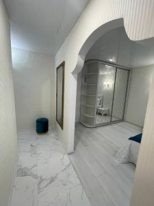 Habitación blanca con 1 dormitorio con espejo. en White Apartment, en Dnipro