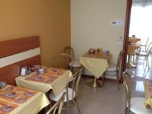 a dining room with two tables and chairs at Hotel GF in Cesano Boscone +42 photos